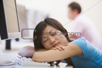Woman in computer room sleeping