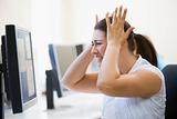 Woman in computer room looking frustrated