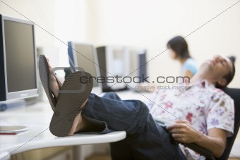 Man in computer room sleeping