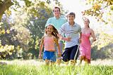 Family running outdoors smiling