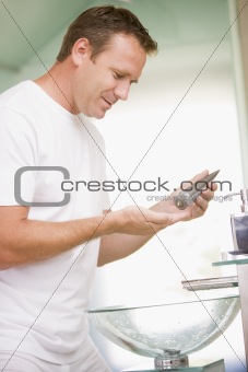 Man in bathroom applying aftershave