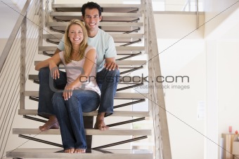 Couple sitting on staircase smiling
