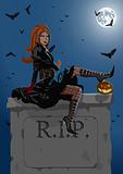 Beautiful witch sitting on the tombstone