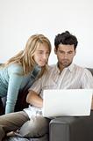 Couple sharing time with a laptop at home