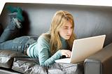 Young Woman Using Laptop on Sofa