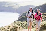 Couple on cliffside outdoors walking and smiling