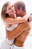 Couple bedroom embracing and smiling