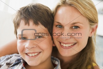 Woman and young boy in living room smiling