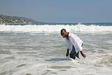 African American Man Running and Playing in the Surf