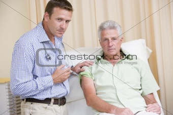 Doctor giving man needle in exam room