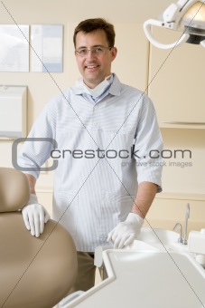 Dentist in exam room smiling
