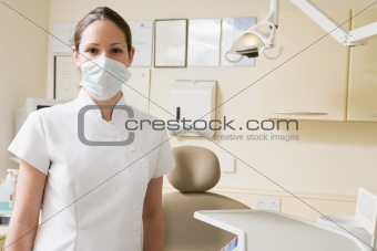 Dental assistant in exam room with mask on