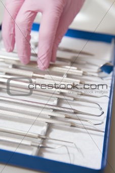 Dental tools with a gloved hand