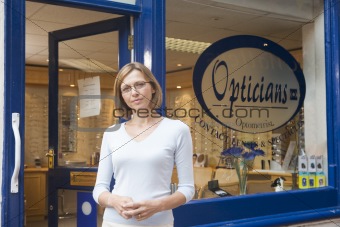 Woman standing at front entrance of optometrists