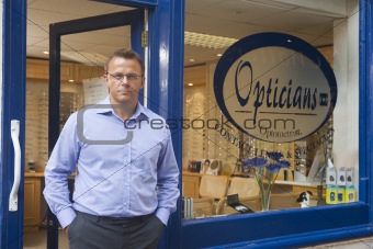 Man standing at front entrance of optometrists
