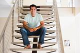 Man sitting on staircase smiling