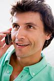 Man using cellular phone and smiling