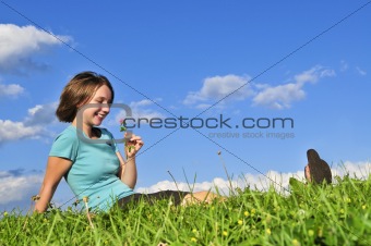 Young girl sitting on grass