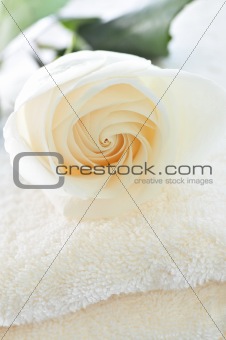 Stack of towels and rose