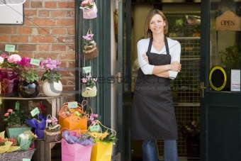 Woman working at flower shop smiling
