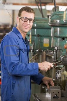 Machinist working on machine