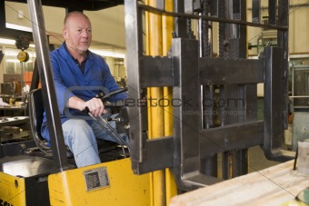 Warehouse worker in forklift