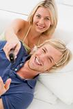 Couple in living room with remote control smiling