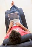 Man sitting in chair using laptop