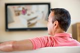 Man in living room watching television