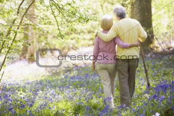 Couple walking outdoors with walking stick