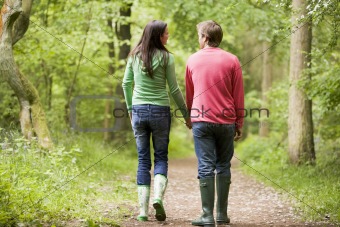 Couple walking on path holding hands