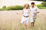 Couple running outdoors smiling