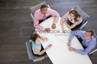 Four businesspeople at boardroom table