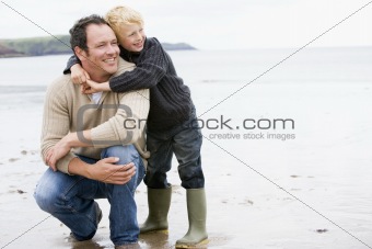 Father and son at beach smiling