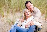 Couple sitting on beach smiling