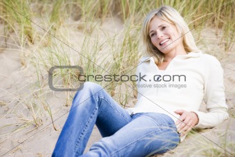 Woman lying on beach smiling