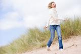 Woman walking on beach smiling