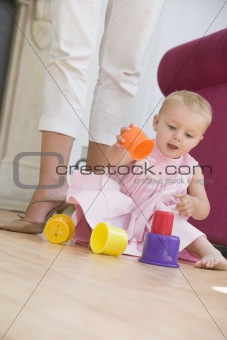 Mother in living room with baby playing