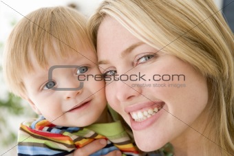 Mother and young boy indoors smiling