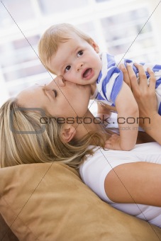 Mother in living room kissing baby