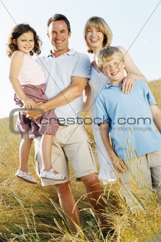 Family standing outdoors smiling