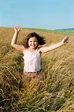 Young girl running outdoors smiling