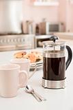 Coffee pot on kitchen counter with scones