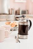 Coffee pot on kitchen counter with scones