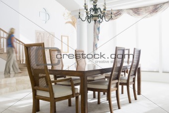 Woman walking by dining room