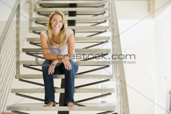 Woman sitting on stairs smiling