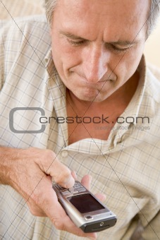 Man using cellular phone indoors