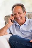 Man indoors using telephone smiling