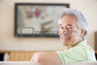 Man watching television smiling