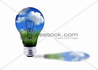 Green Grass and Blue Sky in a Lightbulb Energy Concept